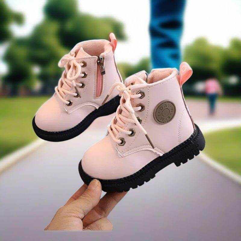 Pink plush kids winter boots, close-up of design detail and material