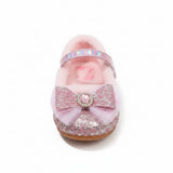 Pink fuzzy slippers with glittery bows on a fluffy white surface