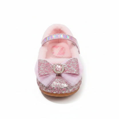 Pink fuzzy slippers with glittery bows on a fluffy white surface