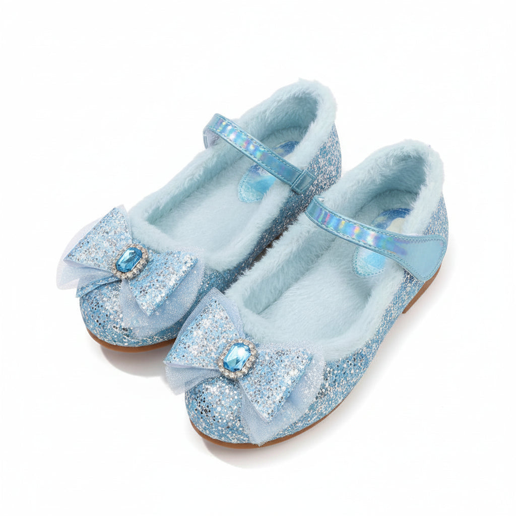 Pair of blue glittery shoes with decorative elements on a soft surface