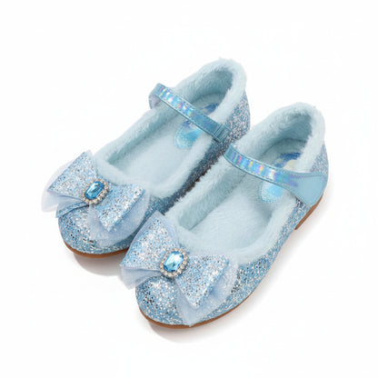 Pair of blue glittery shoes with decorative elements on a soft surface